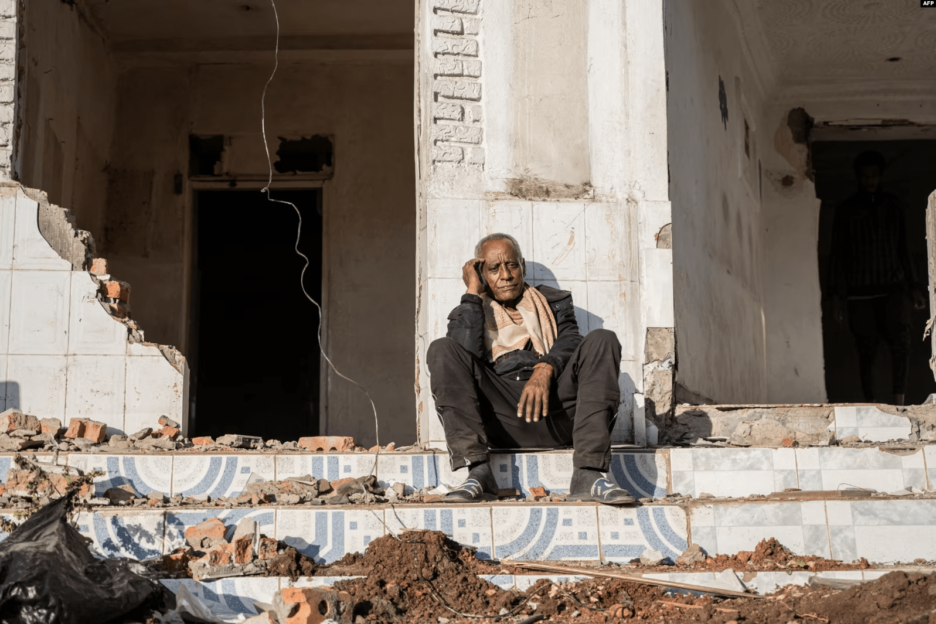 A man sits among the rubbles of a house during a planned demolition in the historical Piazza neighbouhood of Addis Ababa on March 17, 2024. Source: VOA Africa.