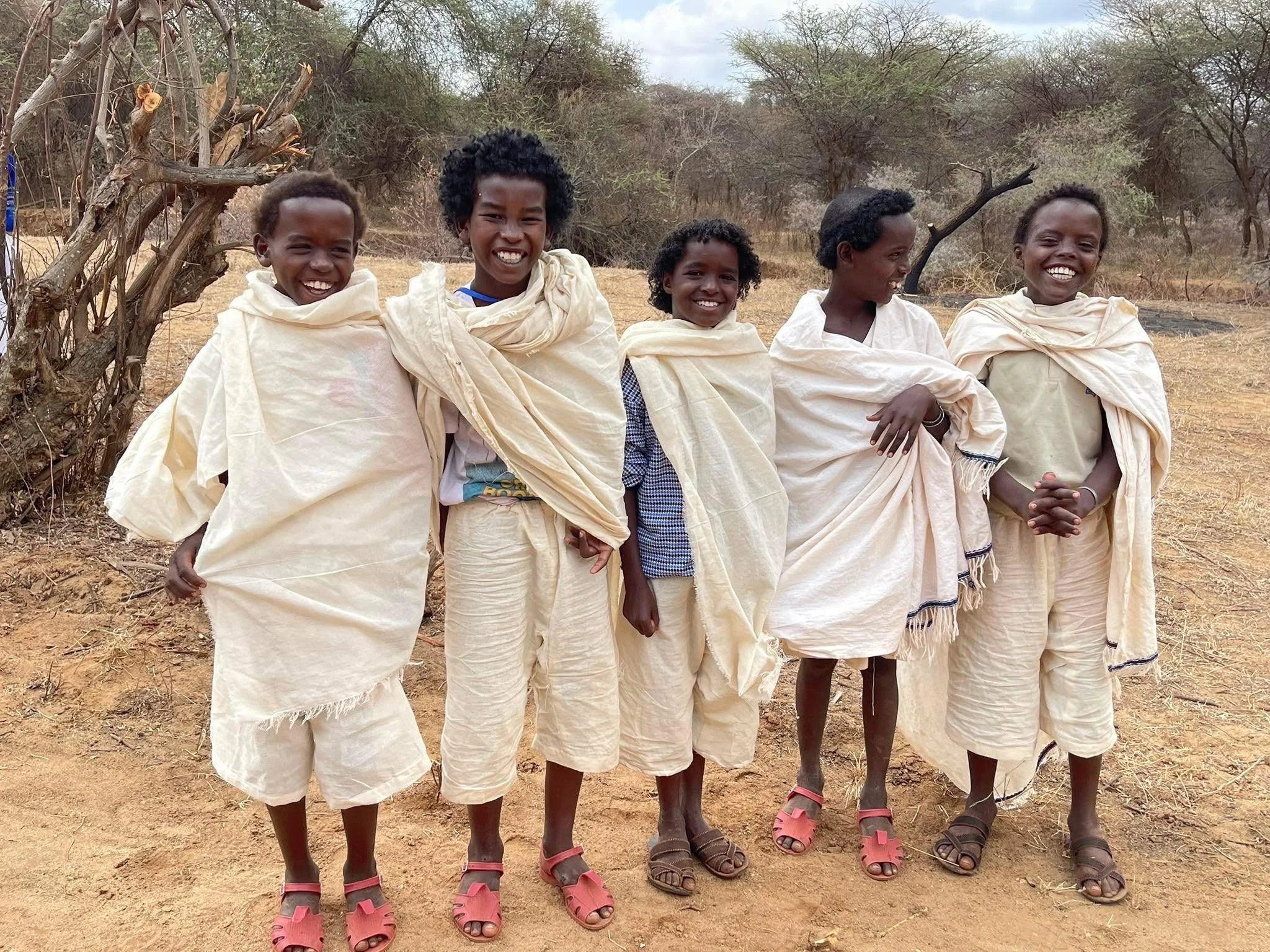 Borana children pose for the camera at a power transfer ceremony, sporting their unique hairstyles that indicate their age set, Gaamme Didiqqo (ages 9–16).